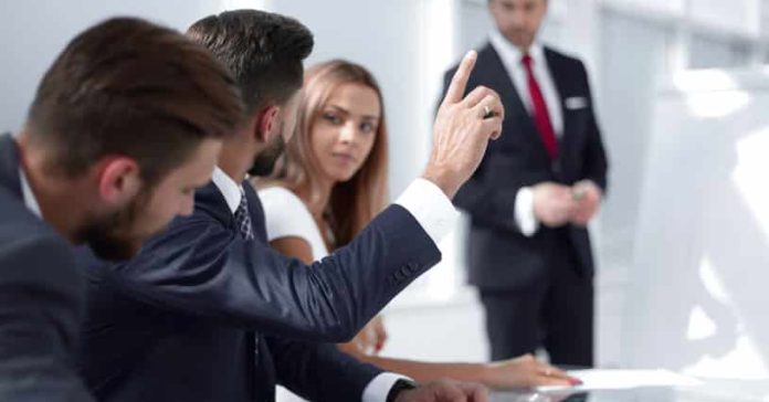 employee at the presentation raise their hands to ask a question.photo with copy space