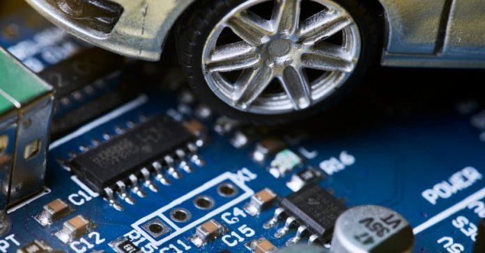 CPU chip and semiconductors with car toy. Global car chip shortage. Micro-chip shortage creates dearth of new cars. Computer chip shortage stalls car industry production