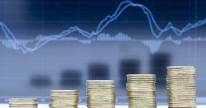 A stack of five rows of coins with graph dark blue background.